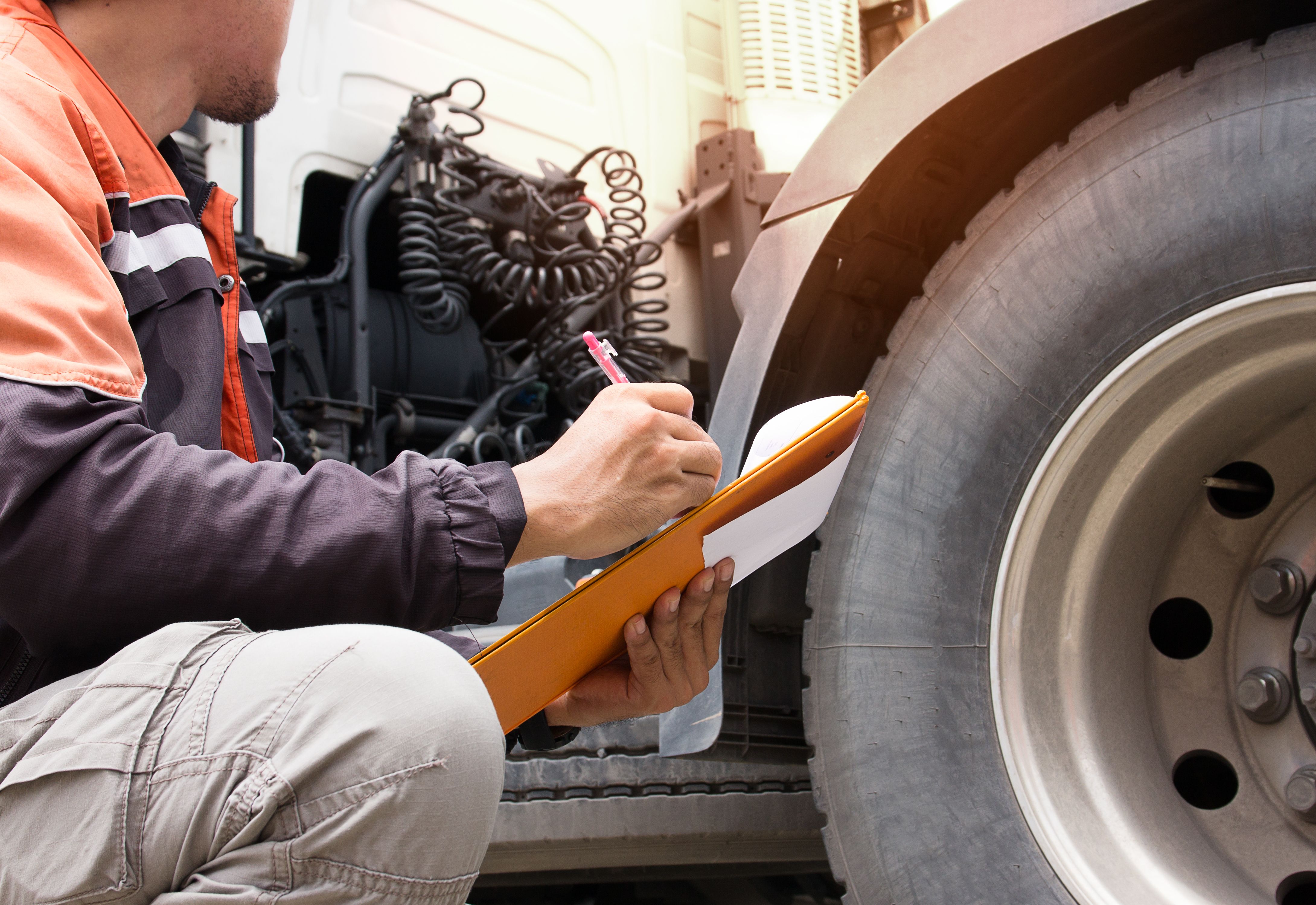 Man inspecting semi truck