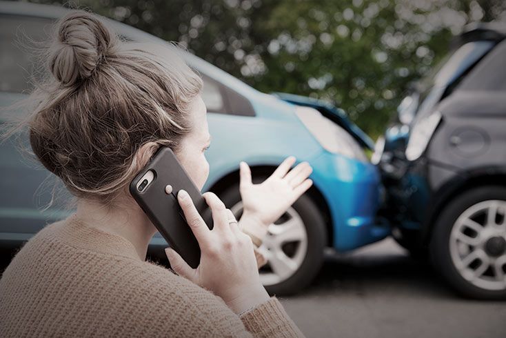 woman using phone after an accident